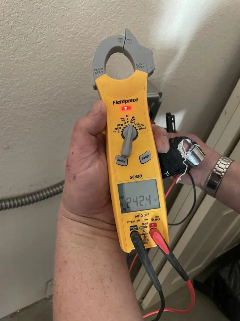 Voltage testing with clamp meter during Recessed Lighting Installation in Dacula